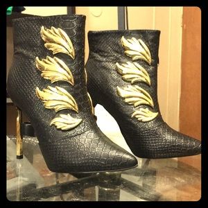 Black winged tip high heel boots.